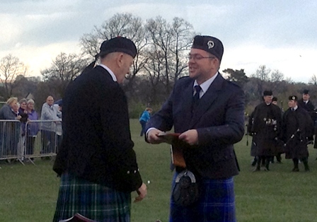 PM Leon Murphy receiving trophy at loch Leven Pipe Band Contest